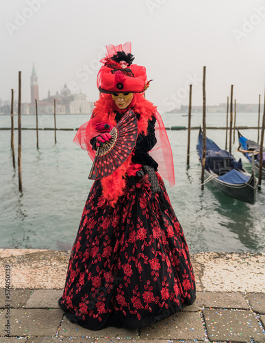 People wearing colorful and elaborate masks and costumes during the Venice carnival in Italy © gammaphotostudio