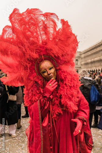 People wearing colorful and elaborate costumes during the Venice carnival in Italy  © gammaphotostudio