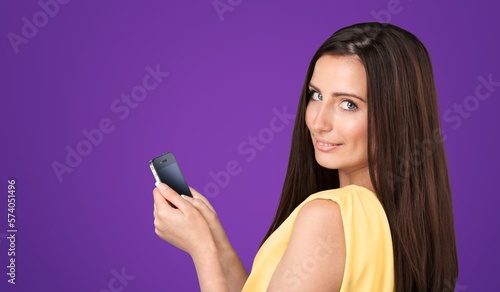 Smiling young woman posing with phone