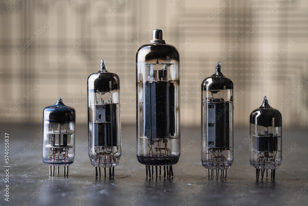 Old diode lamps of different sizes on a table, closeup. Several different vacuum tubes for old radio and TV Old diode lamps of different sizes on a table, closeup. Several different vacuum tubes for old radio and TV
