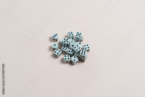 some dice game cubes with black dots on the color surface