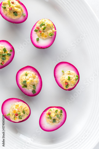 A platter of homemade beet juice soaked devilled eggs for an Easter celebration.