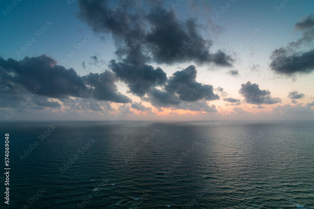 Seascape from above. Panorama of water surface and cloudy sunset