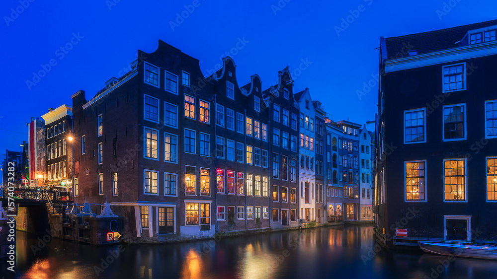 Amsterdam night, red light district night with colorful windows near the basilica of saint nicholas