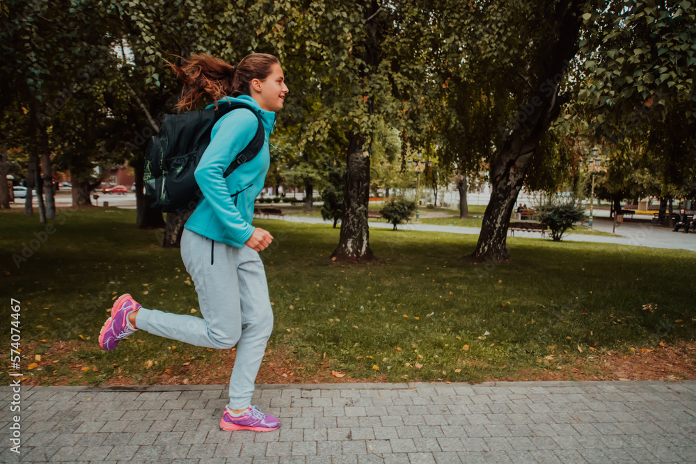 Fototapeta premium Women in sports clothes running in a modern urban environment. The concept of a sporty and healthy lifestyle