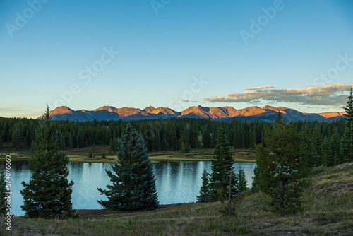 Sunset lake in the mountain forest with clear skies
