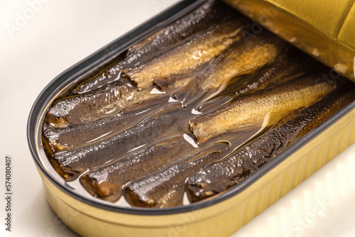Sprats in oil, opened can of canned fish, selective focus