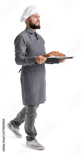 Male baker holding tray wit...