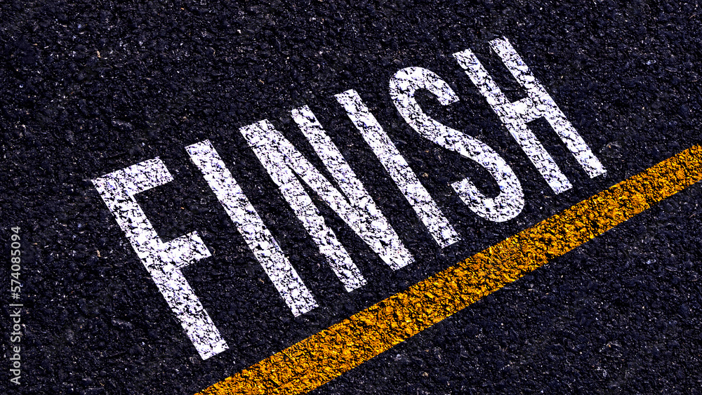 Obraz premium Finish text written and yellow line on the road in middle of the asphalt road, for business planning strategies and challenges, road to success concept, Finish word on street