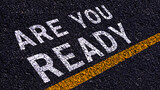 Are you ready written on the middle of the asphalt with yellow line road. Are you ready Write on the road in the middle of the empty asphalt road