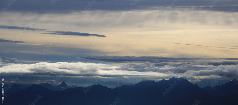 Fototapeta premium Moody sky over mountain ranges in Central Switzerland.