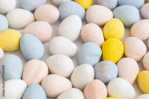 Blue, yellow, pink, and white pastel candy coated chocolate Easter eggs.