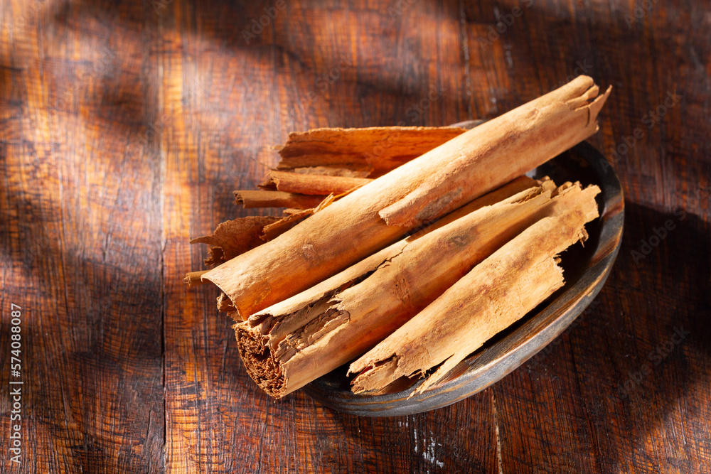 cinnamon chips on rustic wood, close-up view