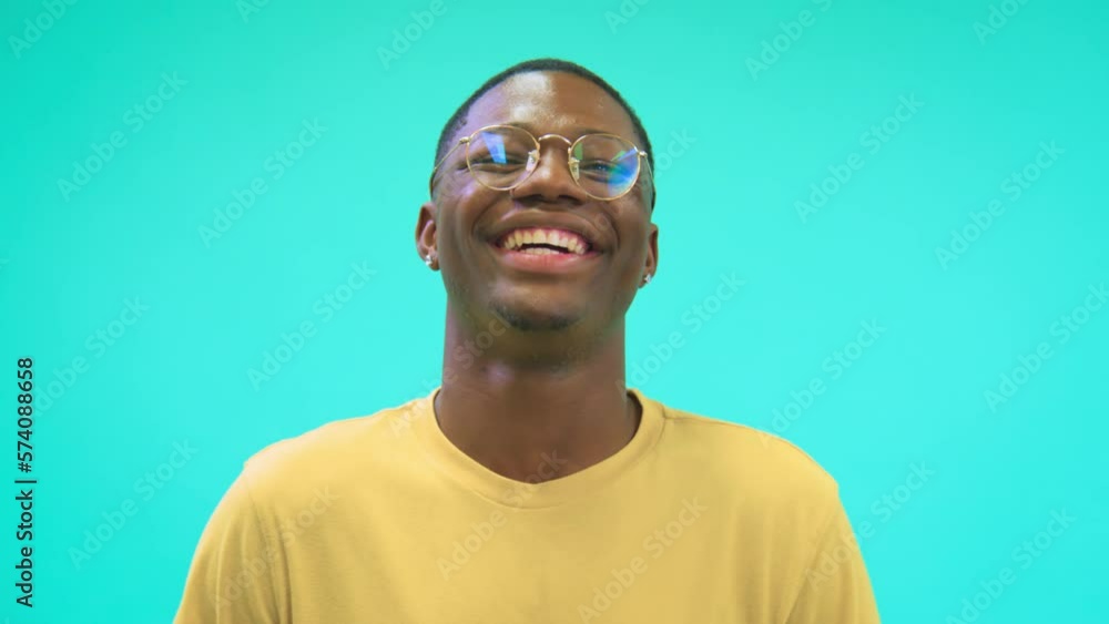 Happy student man smiling and looking at camera, isolated in color studio background with copy space Happy student man smiling and looking at camera, isolated in color studio background with copy space
