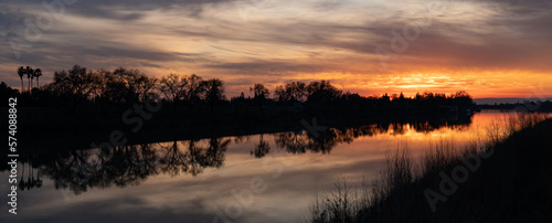 Fototapeta Naklejka Na Ścianę i Meble -  Panorama landscape view of sunset over a river 