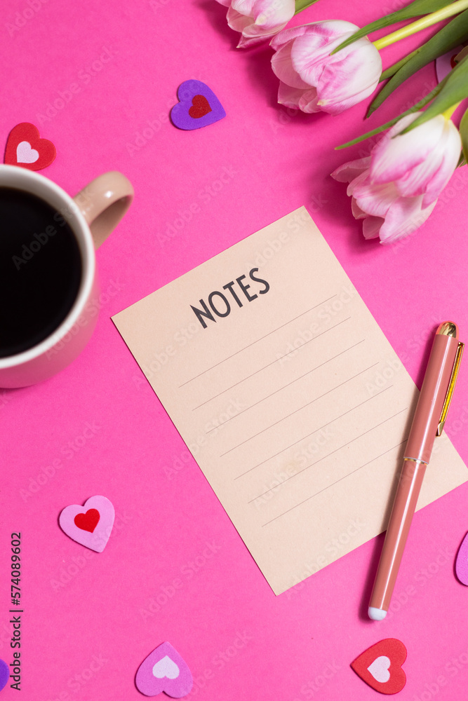 Notes with pen, cup of coffee, tulip spring flower and cute hearts on pink background, flat lay Notes with pen, cup of coffee, tulip spring flower and cute hearts on pink background, flat lay