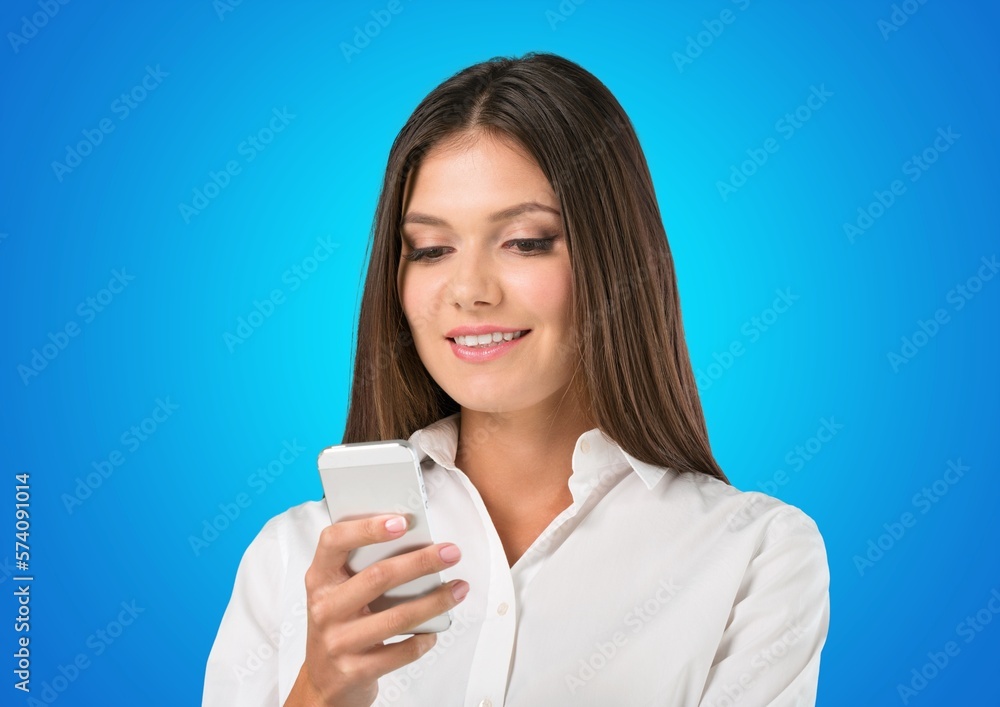 Smiling young woman posing with phone Smiling young woman posing with phone