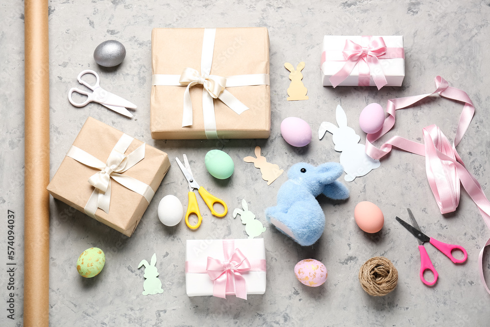 Gifts with Easter eggs and materials on grunge background Gifts with Easter eggs and materials on grunge background
