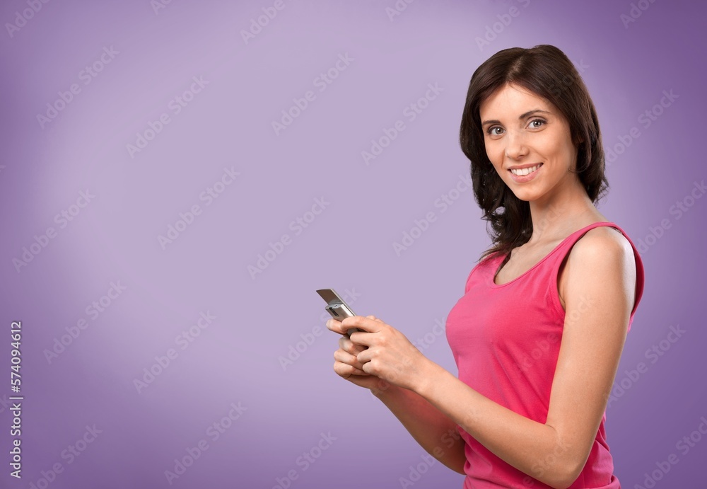 Smiling young woman posing with phone Smiling young woman posing with phone