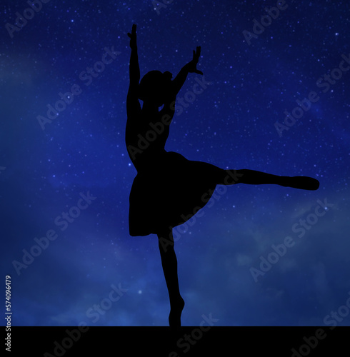 Silhouette of professional gymnast exercising against starry sky