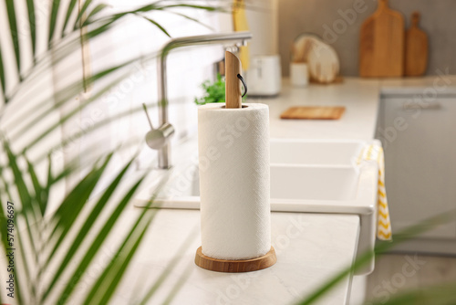 Roll of paper towels on white countertop in kitchen  space for text