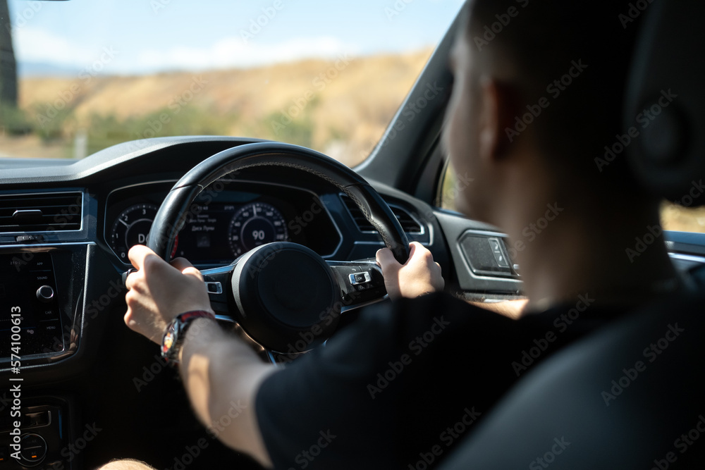 a guy driving a car on a sunny day a guy driving a car on a sunny day