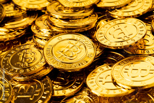 A pile of golden bitcoins placed together