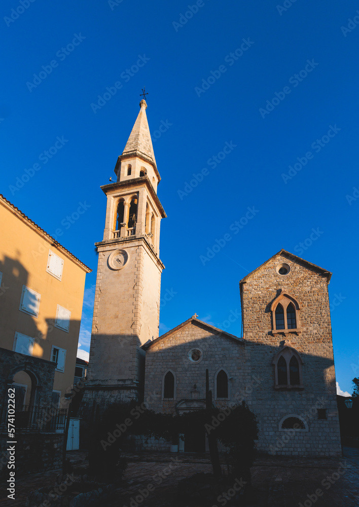 View of Budva old town streets, Budva Municipality and Riviera, resort on the Adriatic sea coast, Montenegro, sunny day with a blue sky, cathedral and citadel, travel to Montenegro