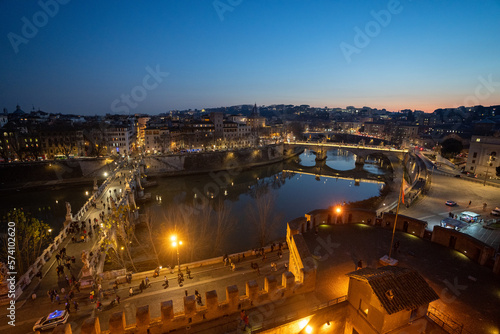 Widok na rzekę Tyber i oświetlone mosty. Widok z okna murów zamku świętego Anioła