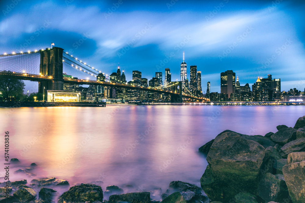 New York city skyline at night and Brooklyn bridge with river Stock ...