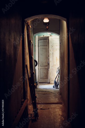 Dimly lit narrow corridor in an old building