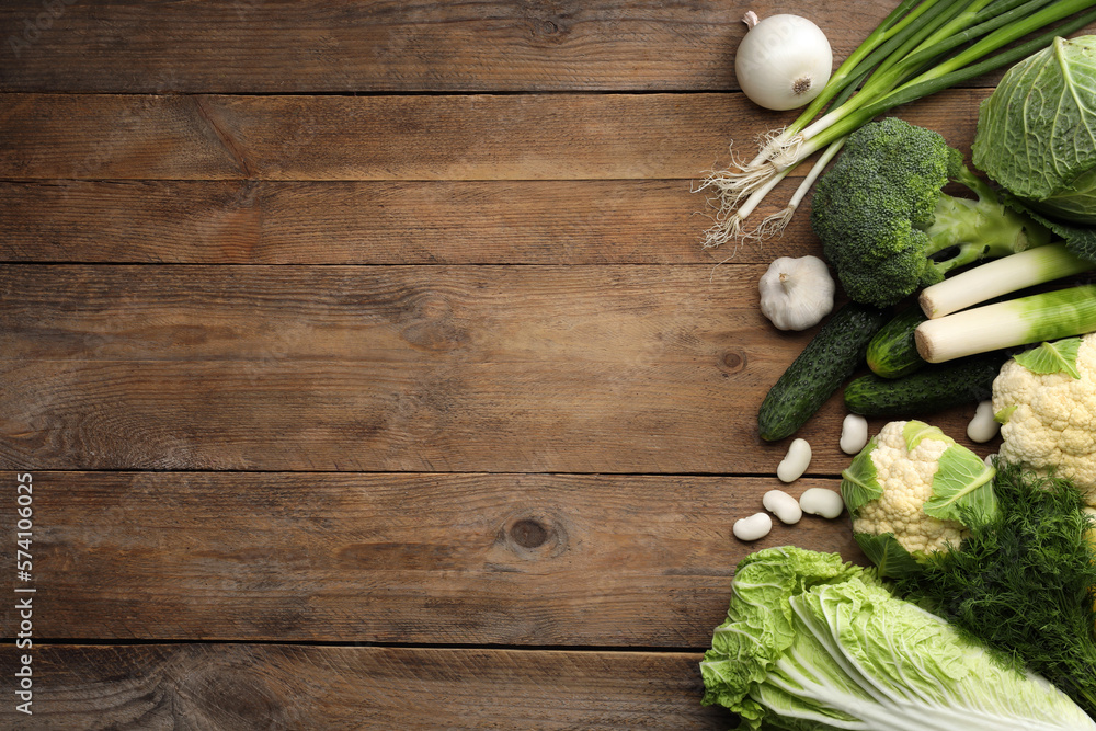 Different fresh ripe vegetables on wooden table, flat lay. Space for text Different fresh ripe vegetables on wooden table, flat lay. Space for text