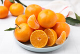 Fresh juicy tangerines on white tiled table