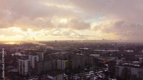 Wallpaper Mural Golden sunset and light snowfall over Riga city suburbs, aerial view Torontodigital.ca