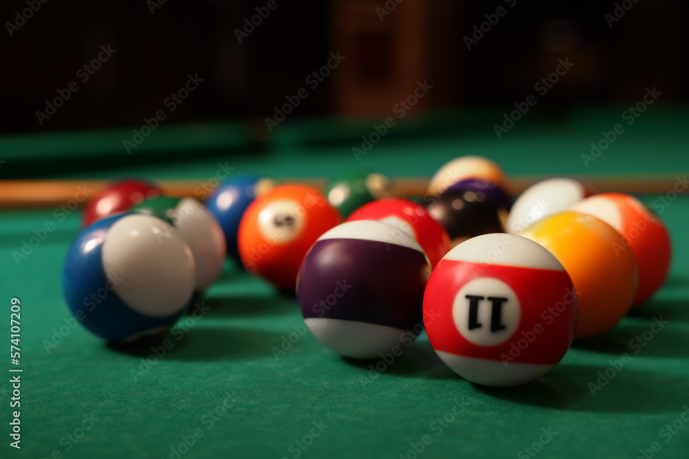 Many colorful billiard balls on green table, closeup Many colorful billiard balls on green table, closeup