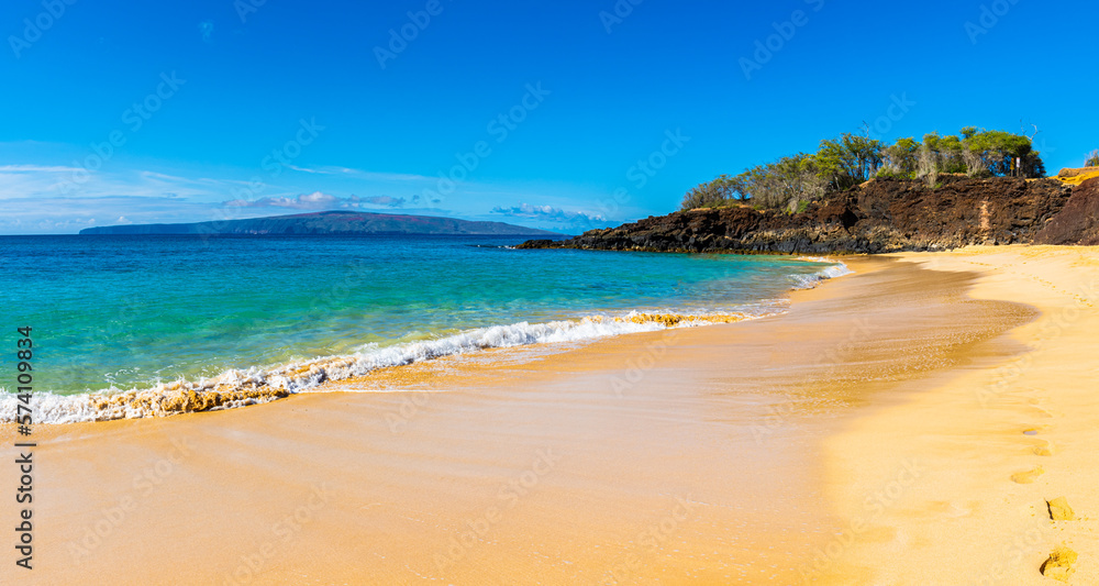 The Sand Covered Shore of Big Beach With Kaho' Olawe Island In The Distance, Makena Beach State Park, Maui, Hawaii, USA The Sand Covered Shore of Big Beach With Kaho' Olawe Island In The Distance, Makena Beach State Park, Maui, Hawaii, USA