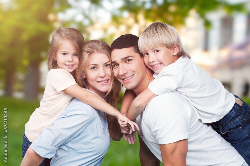 Fototapeta premium Happy young family with child posing in park