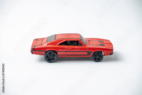 Toy red car on white background