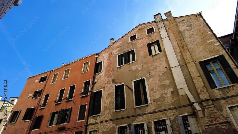 Slowly Deteriorated Walls Of Old Buildings In The Narrow Streets Of Venice, Italy. Low Angle Shot Slowly Deteriorated Walls Of Old Buildings In The Narrow Streets Of Venice, Italy. Low Angle Shot