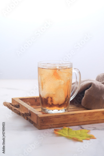 Traditional Ice Tea in a glass on wodden tray
