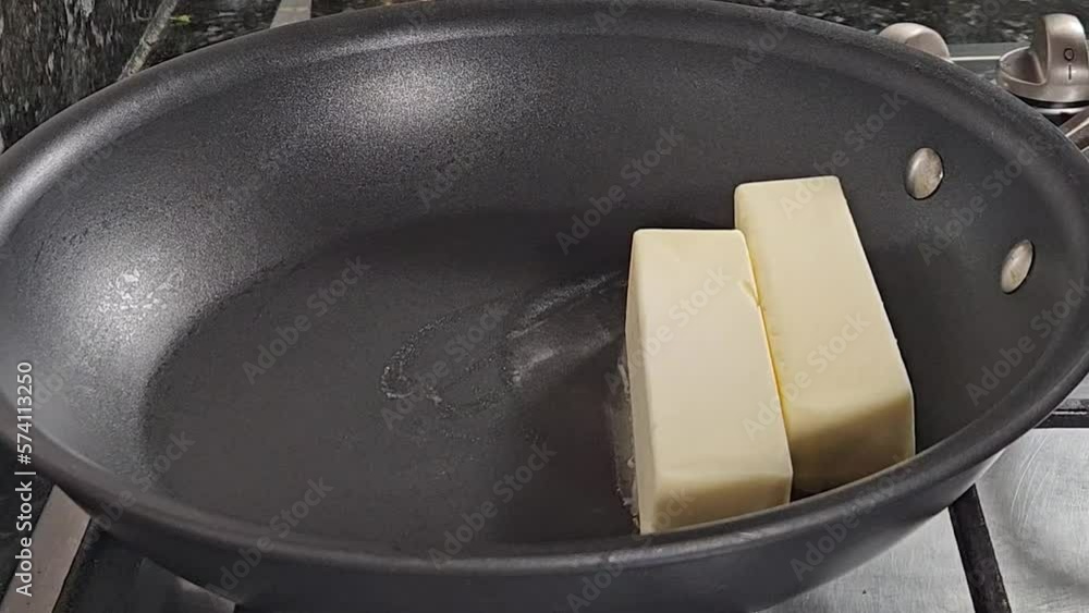 Melting butter sticks to make home made clarified butter also called as