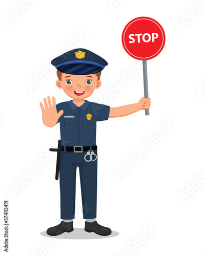 Cute little boy wearing police officer uniform holding stop traffic sign 