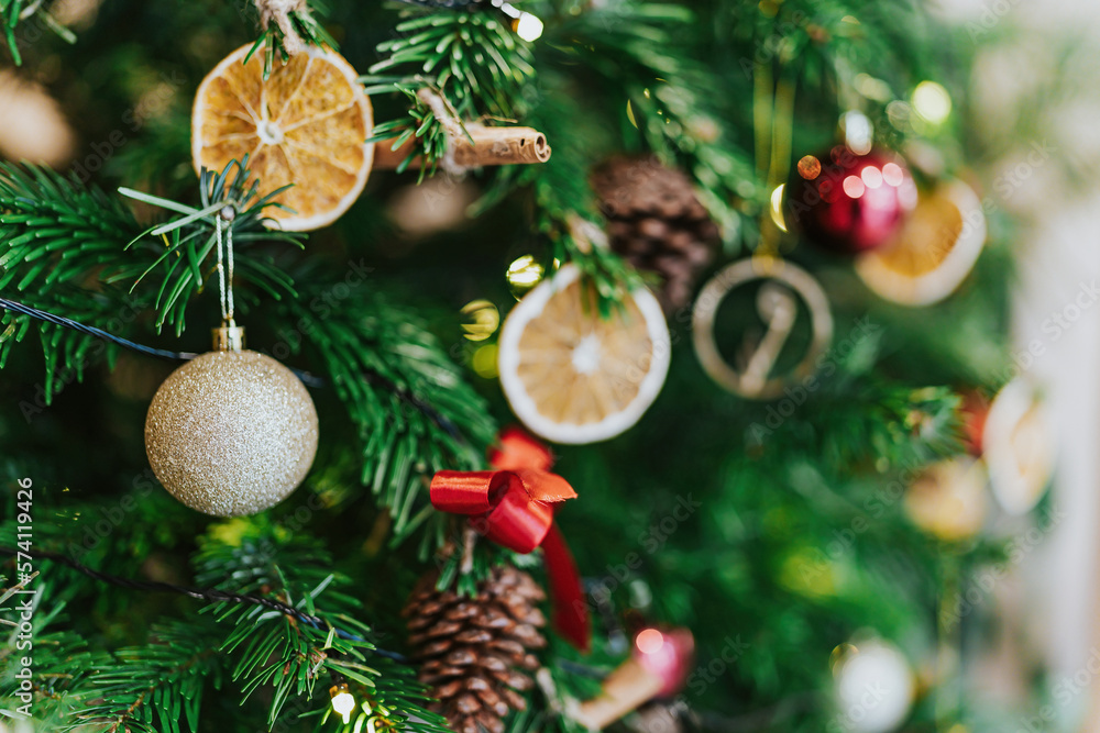 Christmas Tree branches decorated with berries, ribbon, star, pines and red balls Christmas Tree branches decorated with berries, ribbon, star, pines and red balls