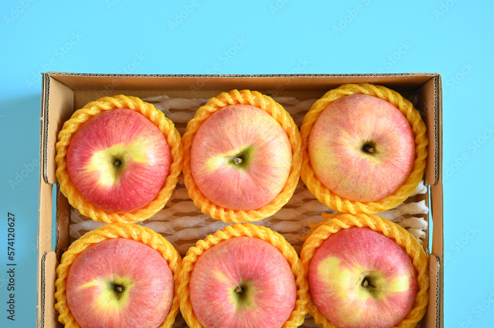 beautiful pink apple in the box on blue background beautiful pink apple in the box on blue background