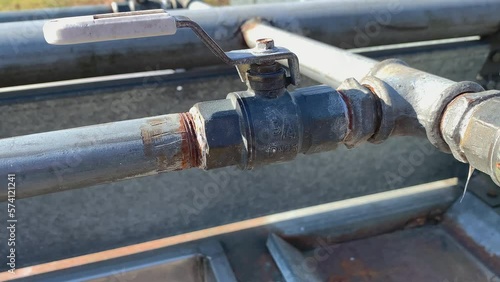 Closeup shot of pipes and water taps. Used for washing carpets in the residential areas of Helsinki. Sunny day. Convenient living conditions for the Finnish people. Camera moving backwards.