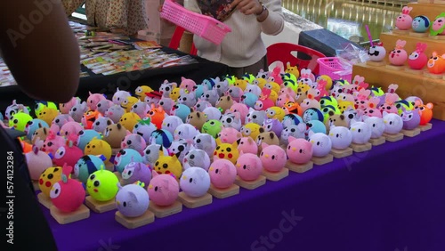 Close up shot of roadside stall selling toy souvenirs in Khlong Hae floating market in Songkhla province, Thailand on a busy day. photo