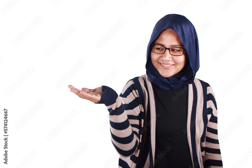 Portrait of Asian young happy muslim woman smiling and presenting something on her empty open palm hand, isolated Portrait of Asian young happy muslim woman smiling and presenting something on her empty open palm hand, isolated
