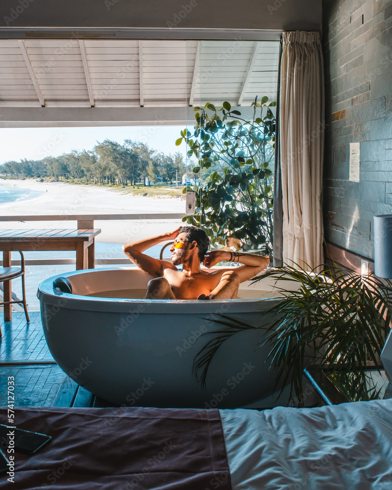 man relaxing in a jacuzzi at home man relaxing in a jacuzzi at home