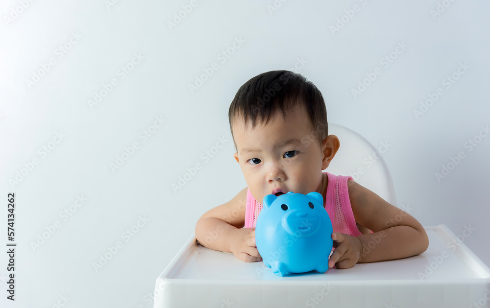Asia baby boy saving money for future concept on white background, Happy baby with a piggy bank Asia baby boy saving money for future concept on white background, Happy baby with a piggy bank