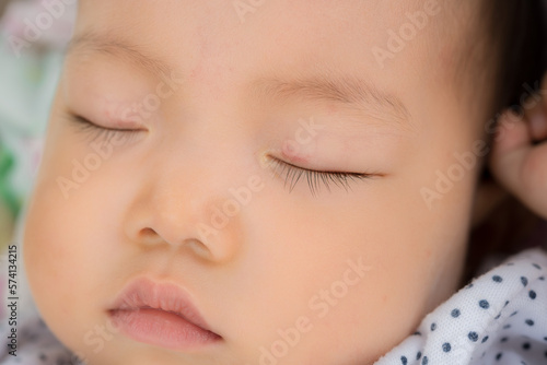 close-up portrait of a sleeping asiab baby outdoor